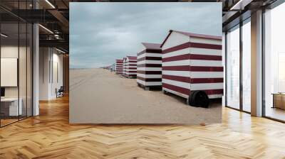 Row of colorful beach cabins on a cloudy day in De Panne, Belgium. Wall mural