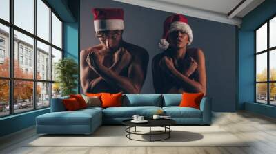 Surprised young Santa couple friends man woman  Wall mural