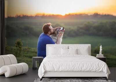 Happy dog and man playing outdoor Wall mural