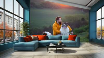 Happy dog and man playing outdoor Wall mural