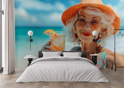 Old woman with cocktail on the beach. Summer vacation concept. Wall mural