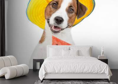 Happy jack russell terrier puppy wearing summer hat holds a watermelon in it paw above empty white banner.  isolated on white background Wall mural