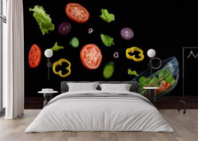 ingredients vegetable salad flying into the bowl on a black background Wall mural