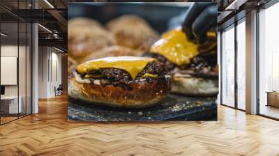 A hamburger with cheddar prepared for service on the grill Wall mural