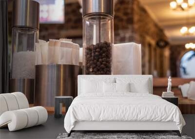 Salt and pepper grinder, pocket sugar, napkin on restaurant or cafe wooden  table.  Wall mural