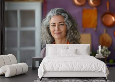 gray hair busines woman in her own business wearing an orange apron Wall mural