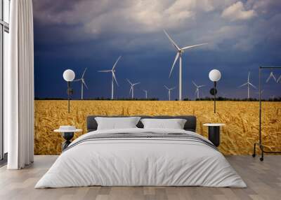 Wind turbines and agricultural field on a summer cloudy day. Energy production, clean and renewable energy. Wall mural