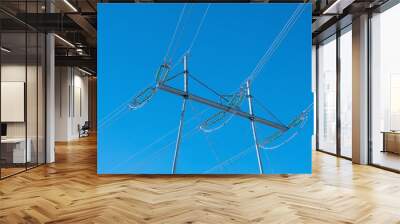 high voltage power lines with metallic pylons on blue sky Wall mural