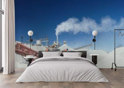 Panorama of industrial stone crushing equipment on the background of hills of crushed stone and blue sky. Wall mural