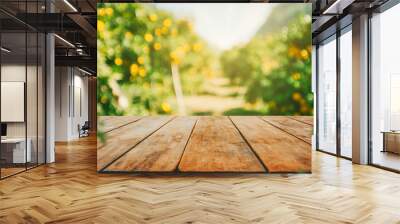 Empty wood table with free space over orange trees, orange field background. For product display montage Wall mural