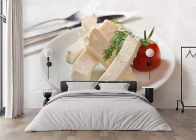 cheese on plate on white background Wall mural