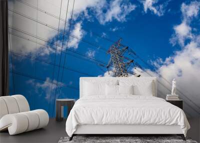 Electric pole, power plant with clouds in blue sky Wall mural