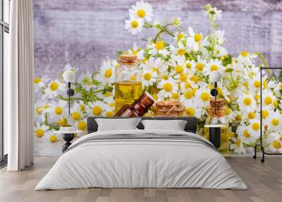 Essential oil in glass bottle with fresh chamomile flowers, beauty treatment. Wall mural