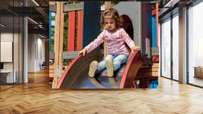 A child slides down Wall mural