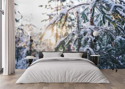 Winter Christmas idyllic landscape. White trees in forest covered with snow, snowdrifts against sunset nature outdoors. Splendid Christmas scene in the fabulous forest. Wall mural