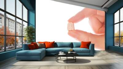 Ecstasy pill in a woman's hand isolated on white background. Wall mural