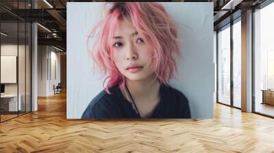 a woman with pink hair is sitting in front of a white wall Wall mural