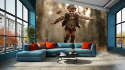 A young boy is jumping in the woods, surrounded by fallen leaves Wall mural