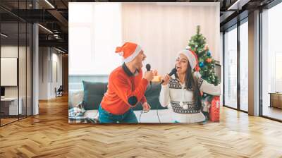 Active couple standing together and singing. They move and dance. Guy looks at girl. They are concentrated on singing out loud. Wall mural