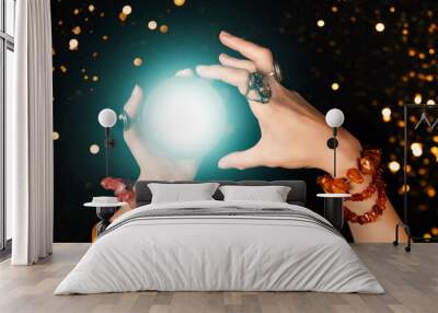 Fortune teller or witch hands and a glowing magic ball. Halloween, magic or witchcraft and tricks concept Wall mural