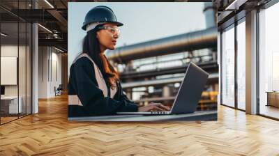 Female engineer and laptop working at oil and gas plant Wall mural