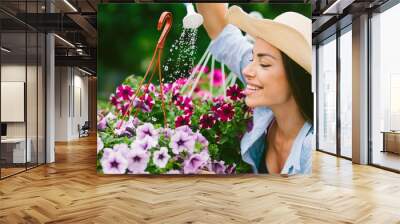 The attractive woman watering flowers on a porch of her house, houseplants, hobby, Wall mural