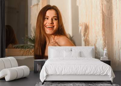 Happy young woman feeling relaxed and fresh on a clear morning. Wall mural