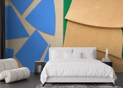 cut blue and gold paper shapes on beige and green corrugated texture Wall mural