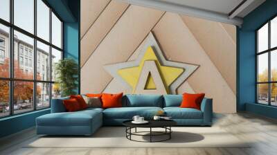 the letter A on two wooden stars (one yellow) on old, faded paper  Wall mural