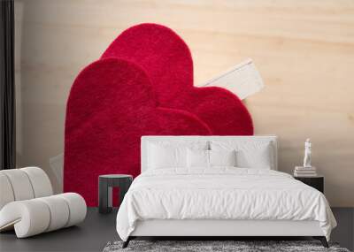 two red felt heart on wooden background Wall mural