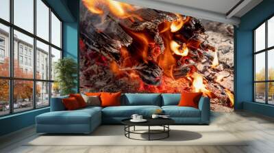 A bonfire, a burning log, flames and coals. Wall mural