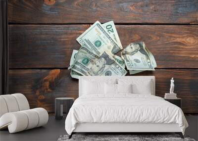 Crumpled banknotes on a wooden background. Crumpled dollars studio image. Wall mural