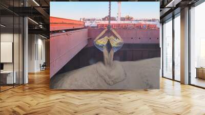 Loading of wheat, barley in bulk using steel grab into cargo hold of bulk carrier, cargo ship Wall mural