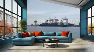 Logistics and transportation of Container Cargo ship and Cargo plane with working crane bridge in shipyard at sunrise, logistic import export and transport Wall mural