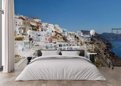 view with traditional white buildings over the village of Oia Wall mural