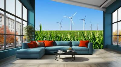 wind turbines in the distance on top of a green corn field, blue sky Wall mural