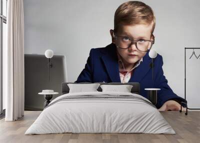 Young businessman using a laptop.little handsome boy in office Wall mural