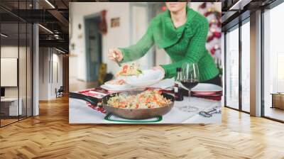 Close up on the hand of young handsome girl serving rice and veg Wall mural