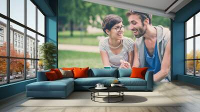 couple of friends young  man and woman using smartphone Wall mural