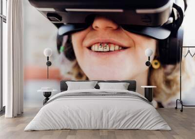 Diverse young pierced woman toothy smile enjoying augmented reality wearing vr headset videogaming metaverse 5g technology Wall mural