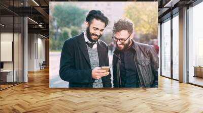 half length of two young bearded modern businessman using smart Wall mural