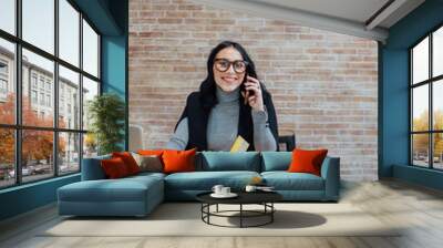 Smiling happy caucasian young woman working from home having conversation Wall mural