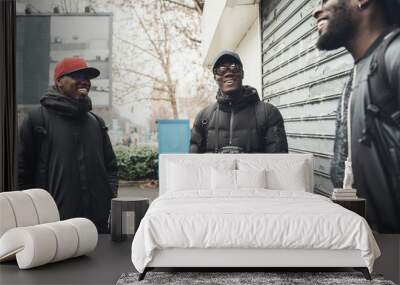 three african men standing in the street and having conversation Wall mural