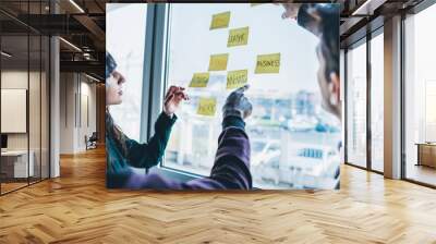 Three business people having a meeting in office. They are stand Wall mural