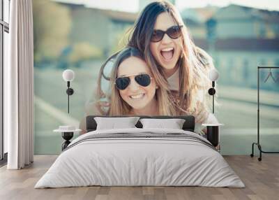 two beautiful young women having fun Wall mural