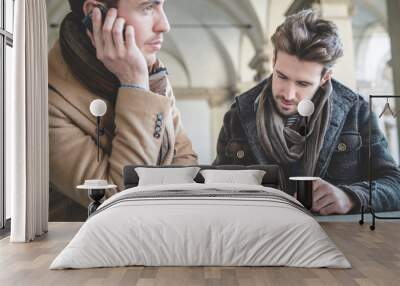 two young handsome businessmen using tablet Wall mural