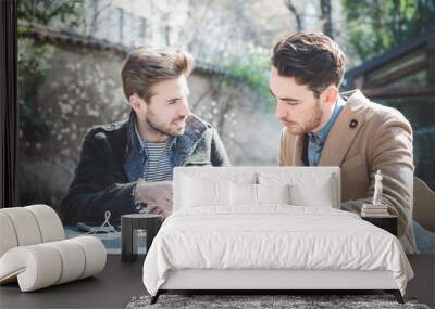 two young handsome fashion model businessmen using tablet Wall mural