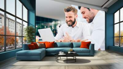 two young modern businessman using laptop Wall mural