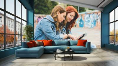 two young women outdoor using smart phone having fun - technology, social network, communication concept Wall mural