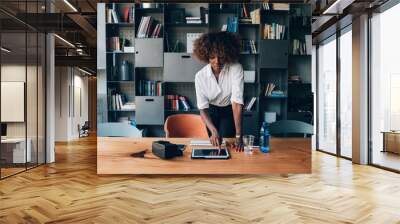 young black woman using tablet in modern office Wall mural